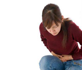 A young woman suffering from abdominal pain