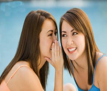 Twin Sisters Telling Secrets --- Image by © Rick Gomez/Corbis